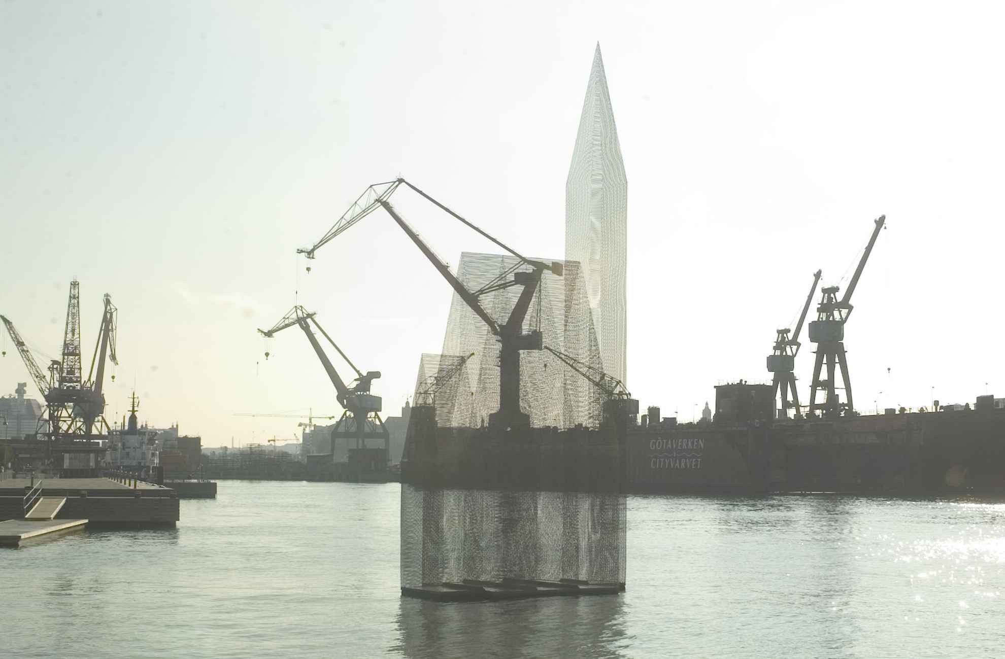 A transparent church-like sculpture called ‘Temple of Doubt and Hope’ floats on the water in in Gothenburg harbour basin. Several construction cranes is seen in the background.