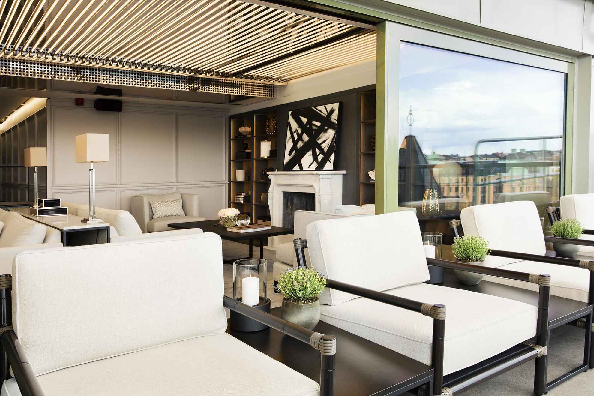 La terrasse du bar Le Hibou avec des meubles d'extérieur recouverts de coussins blancs.