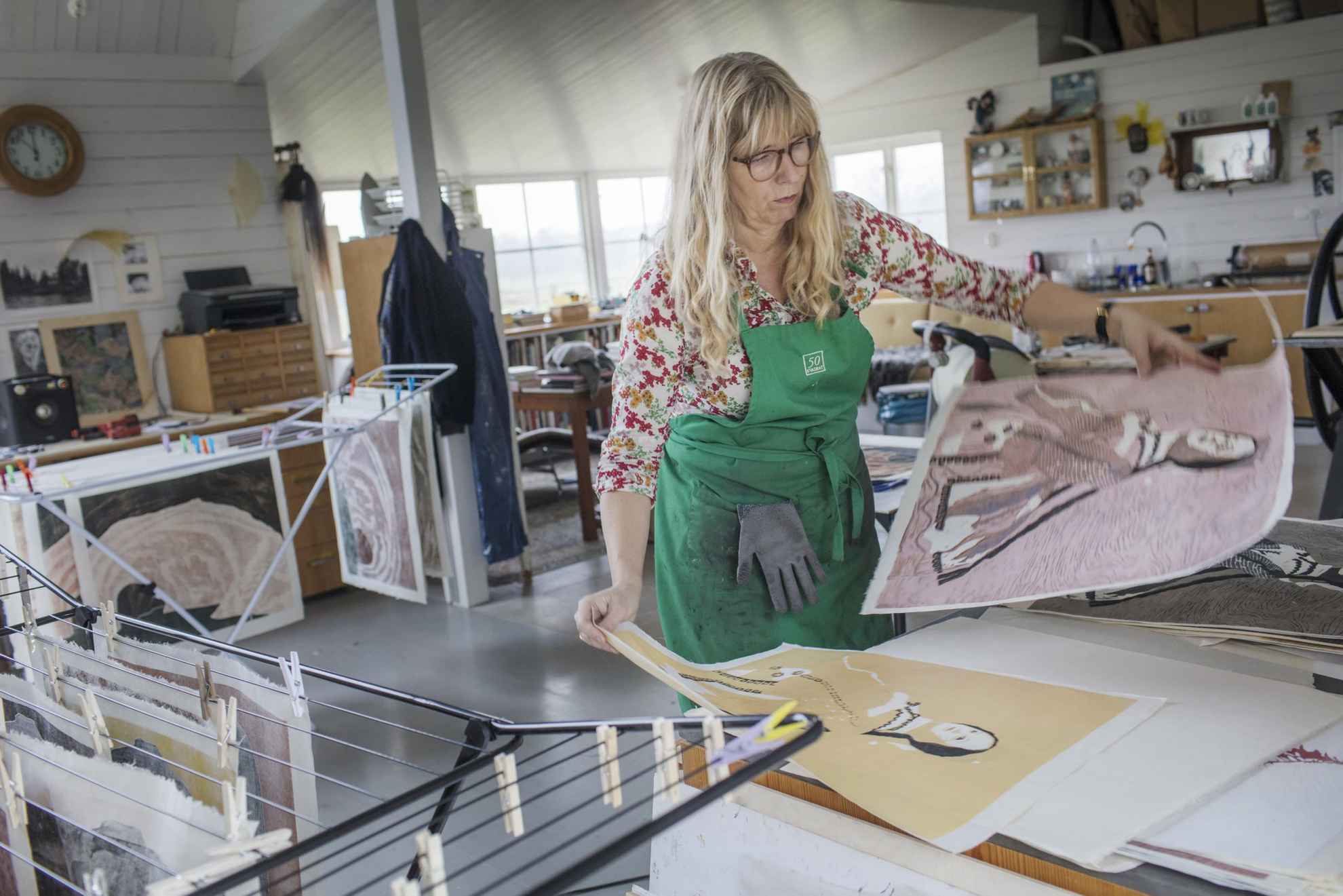 The artist Karin Mamma Andersson is working with prints in her studio.