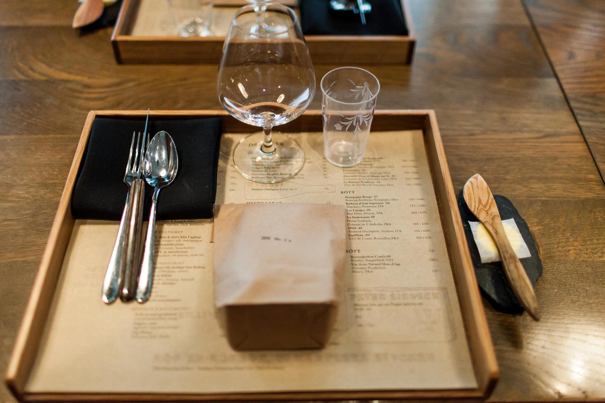 A neat table setting with cutlery, menus and plates at a culinary restaurant in Stockholm.
